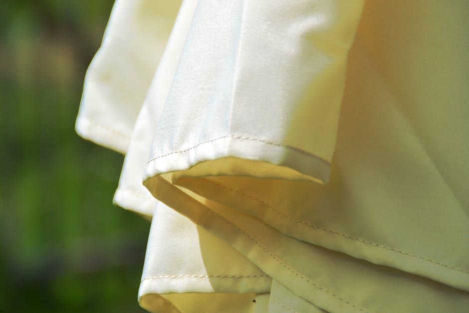 Detailed view of sunlit beige fabric, perfect for outdoor summer themes.